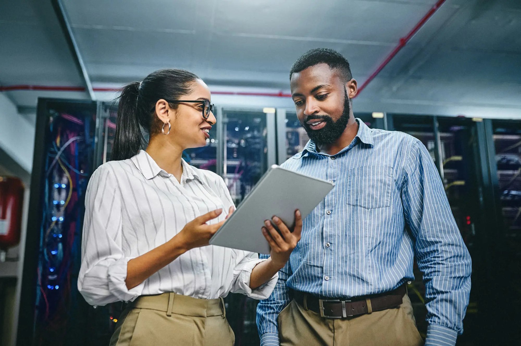 A man and woman looking at an iPad